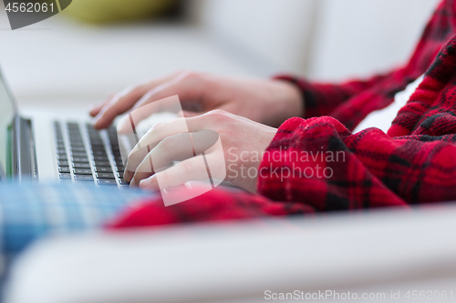 Image of man freelancer in bathrobe working from home