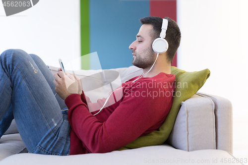 Image of man enjoying music through headphones