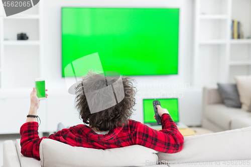 Image of young man in bathrobe enjoying free time