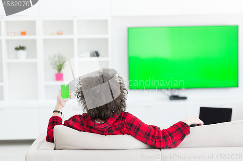 Image of young man in bathrobe enjoying free time