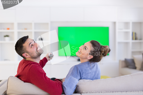 Image of Young couple on the sofa watching television