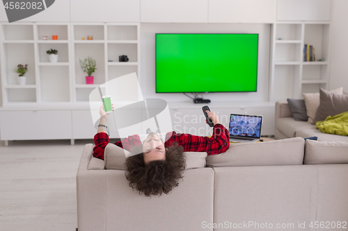 Image of young man in bathrobe enjoying free time