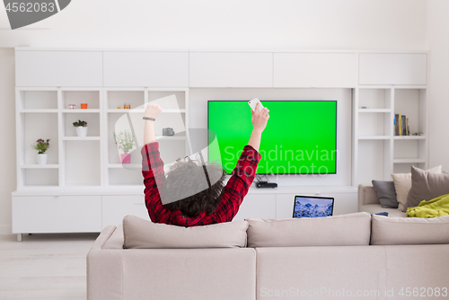 Image of young man in bathrobe enjoying free time