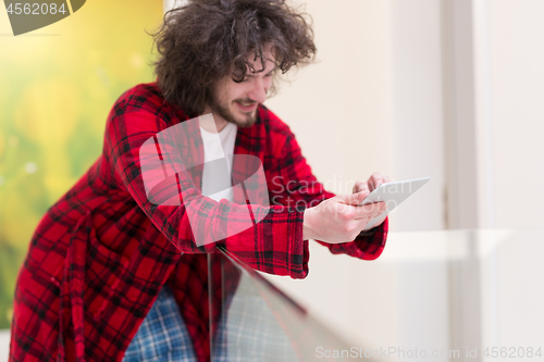 Image of young freelancer using tablet computer