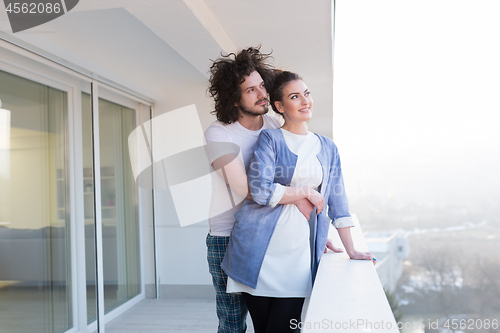 Image of Couple hugging on the balcony