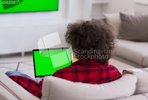 Image of man freelancer in bathrobe working from home