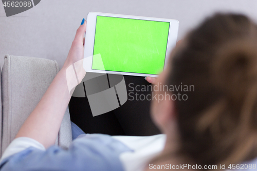 Image of woman on sofa using tablet computer