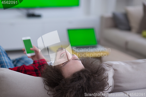 Image of young man in bathrobe enjoying free time