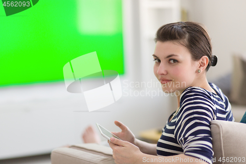 Image of woman on sofa using tablet computer