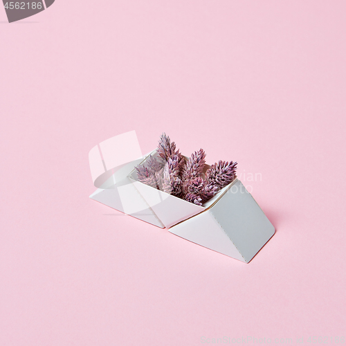 Image of Composition of paper triangular boxes with cones on a pink background with copy space. Layout for postcard