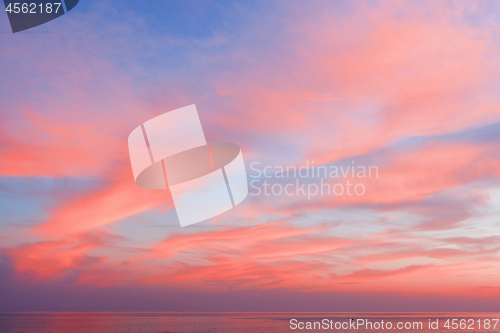 Image of View of the blue-pink sky with clouds at sunset in the background of the sea. Beautiful natural layout