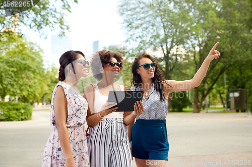 Image of women with tablet pc on street in summer