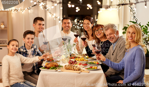 Image of happy family having dinner party at home