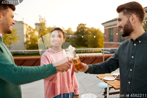 Image of friends toast drinks at barbecue party on rooftop