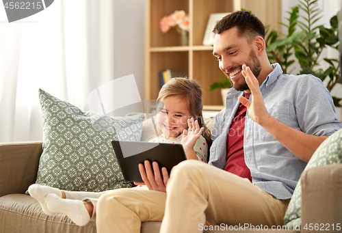 Image of father and daughter having video call on tablet pc
