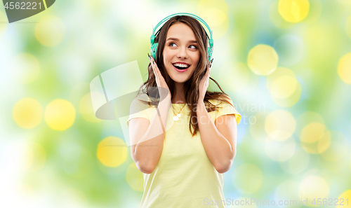 Image of happy young woman or teenage girl with headphones