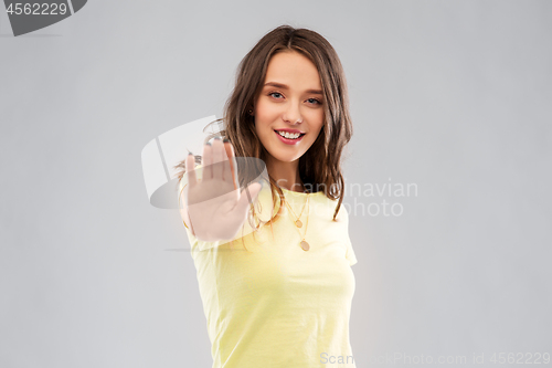 Image of young woman or teenage girl showing stop gesture