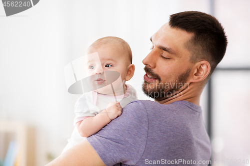 Image of father with little baby girl at home