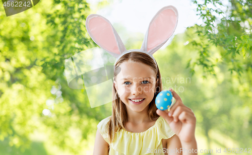 Image of happy girl with colored easter egg