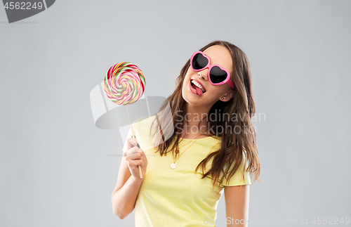 Image of teenage girl in sunglasses with lollipop