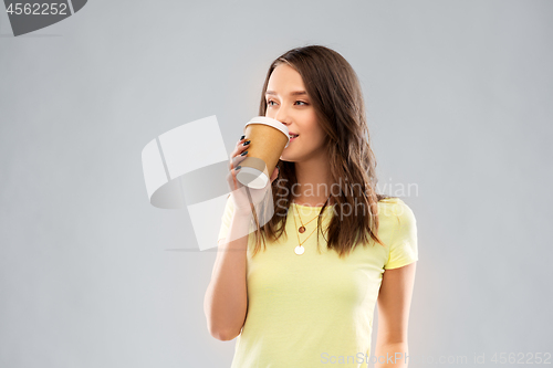 Image of young woman or teenage girl drinking coffee