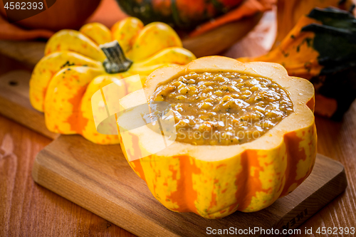 Image of Red lentils soup with pumpkins served in hollowed pumpkin