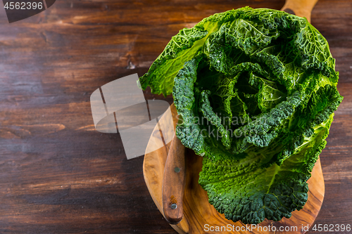 Image of Fresh raw savoy cabbage on wooden background