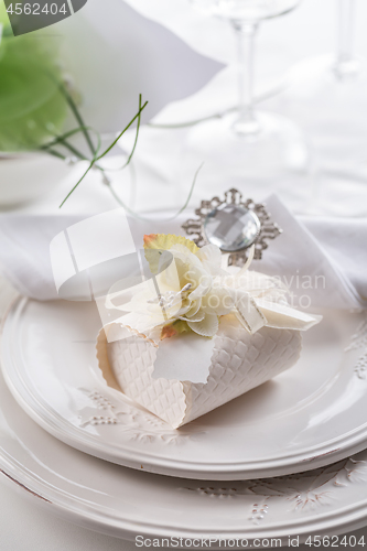 Image of Festive table setting with small gift on plate