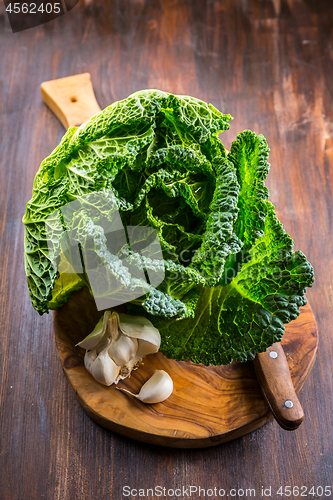 Image of Fresh raw savoy cabbage on wooden background