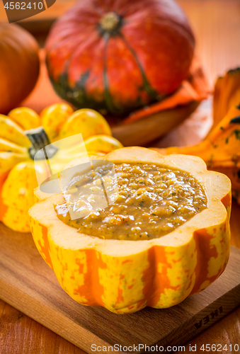 Image of Red lentils soup with pumpkins served in hollowed pumpkin