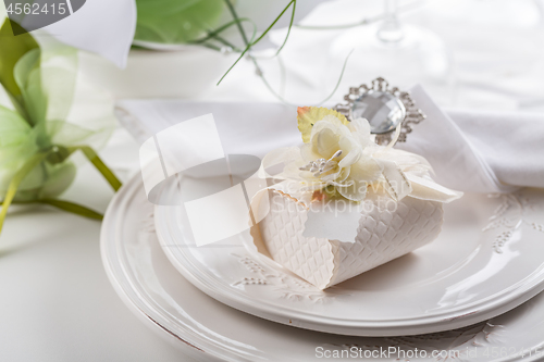 Image of Festive table setting with small gift on plate