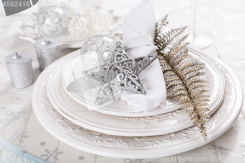 Image of Festive table setting with silver star on plate