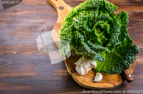 Image of Fresh raw savoy cabbage on wooden background