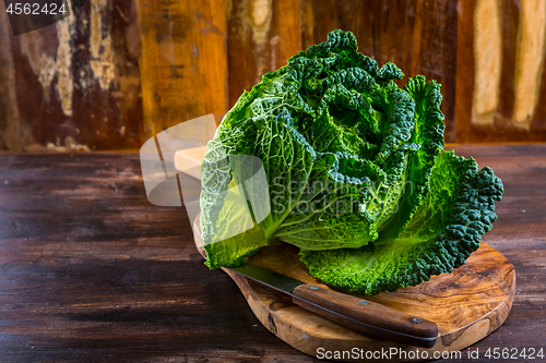 Image of Fresh raw savoy cabbage on wooden background