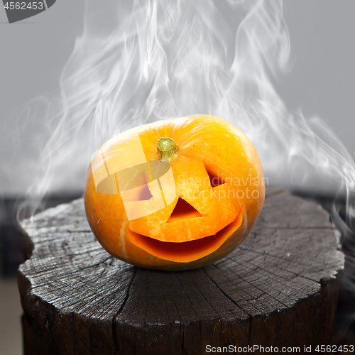 Image of Pumpkin that laughs on a charred stub in smoke