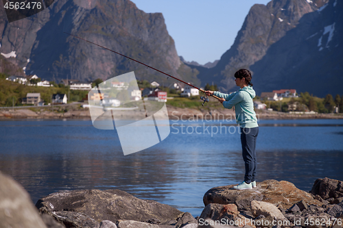 Image of Woman fishing on Fishing rod spinning in Norway.