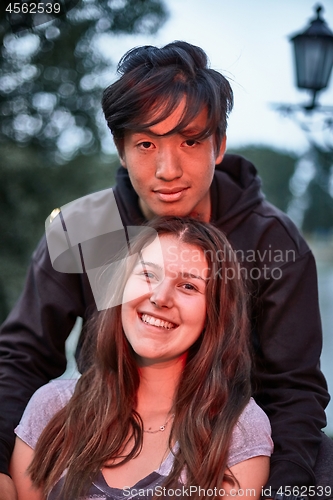 Image of Smiling young girl and guy at dusk