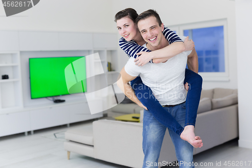 Image of handsome man piggybacking his girlfriend