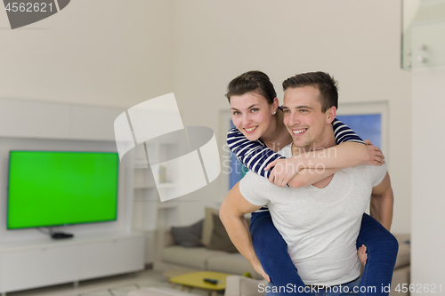 Image of handsome man piggybacking his girlfriend