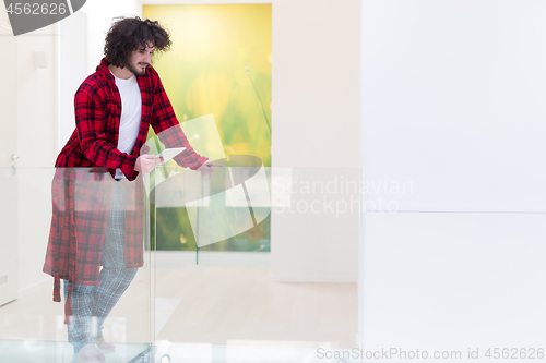 Image of young freelancer using tablet computer