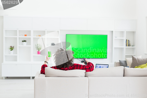 Image of young man in bathrobe enjoying free time