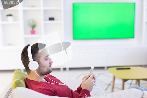 Image of man enjoying music through headphones