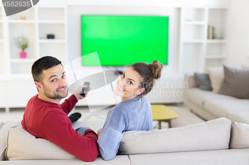 Image of Young couple on the sofa watching television