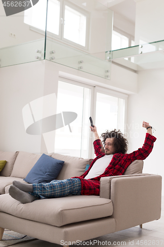 Image of young man in bathrobe enjoying free time