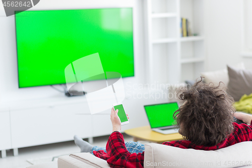 Image of young man in bathrobe enjoying free time