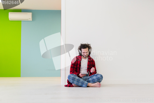 Image of young man enjoying music through headphones