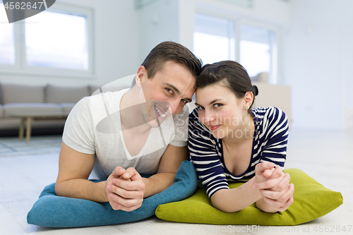 Image of couple lying on the floor at home