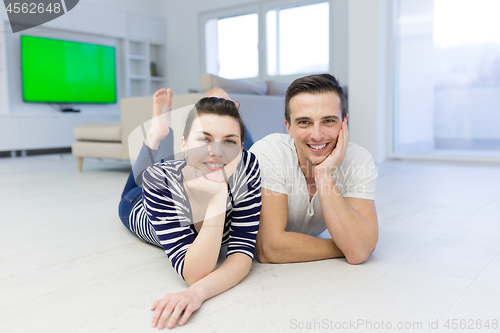 Image of couple lying on the floor at home