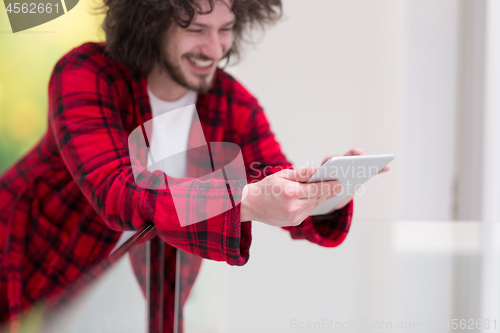 Image of young freelancer using tablet computer