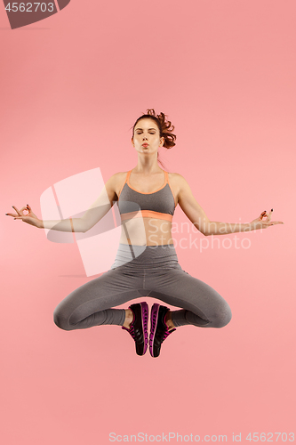 Image of Full length of pretty young woman with mobile phone while jumping